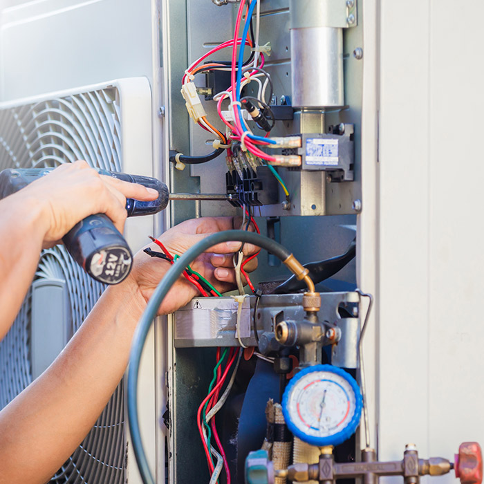 technician-hands-close-up-with-drill-repairing-hvac-unit-many-la