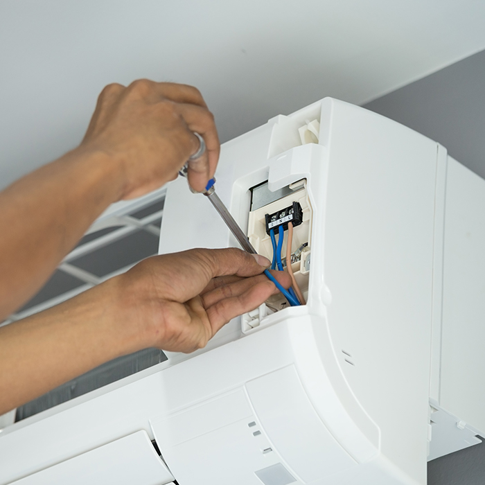 technician-hands-with-screwdriver-close-up-repairing-air-conditioner-unit-many-la