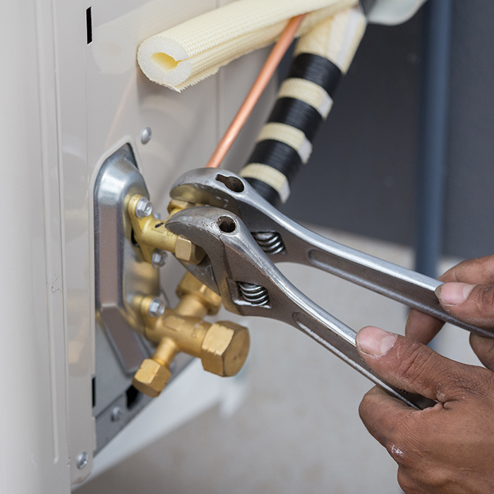 technician-hands-with-tools-close-up-installing-air-conditioner-many-la